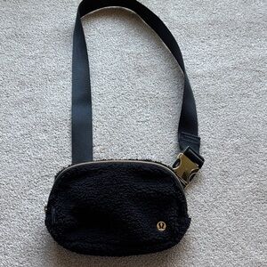 lululemon athletica black sherpa crossbody with gold logo